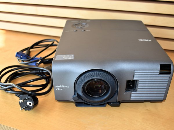 Photo:Projector with VGA cable, VGA to DVI adapter, laser pointer and remote control