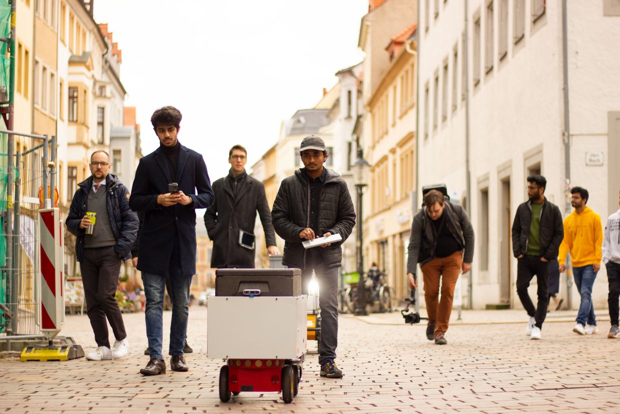 Studenten mit Lieferroboter