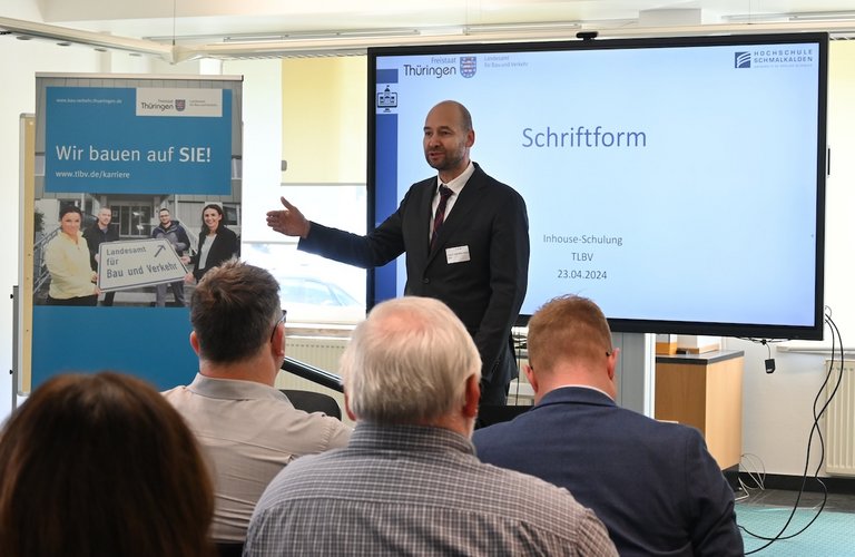 Das Bild zeigt Herrn Prof. Dr. Müller-Grune vor einer Präsentation zum Schriftformerfordernis im TLBV