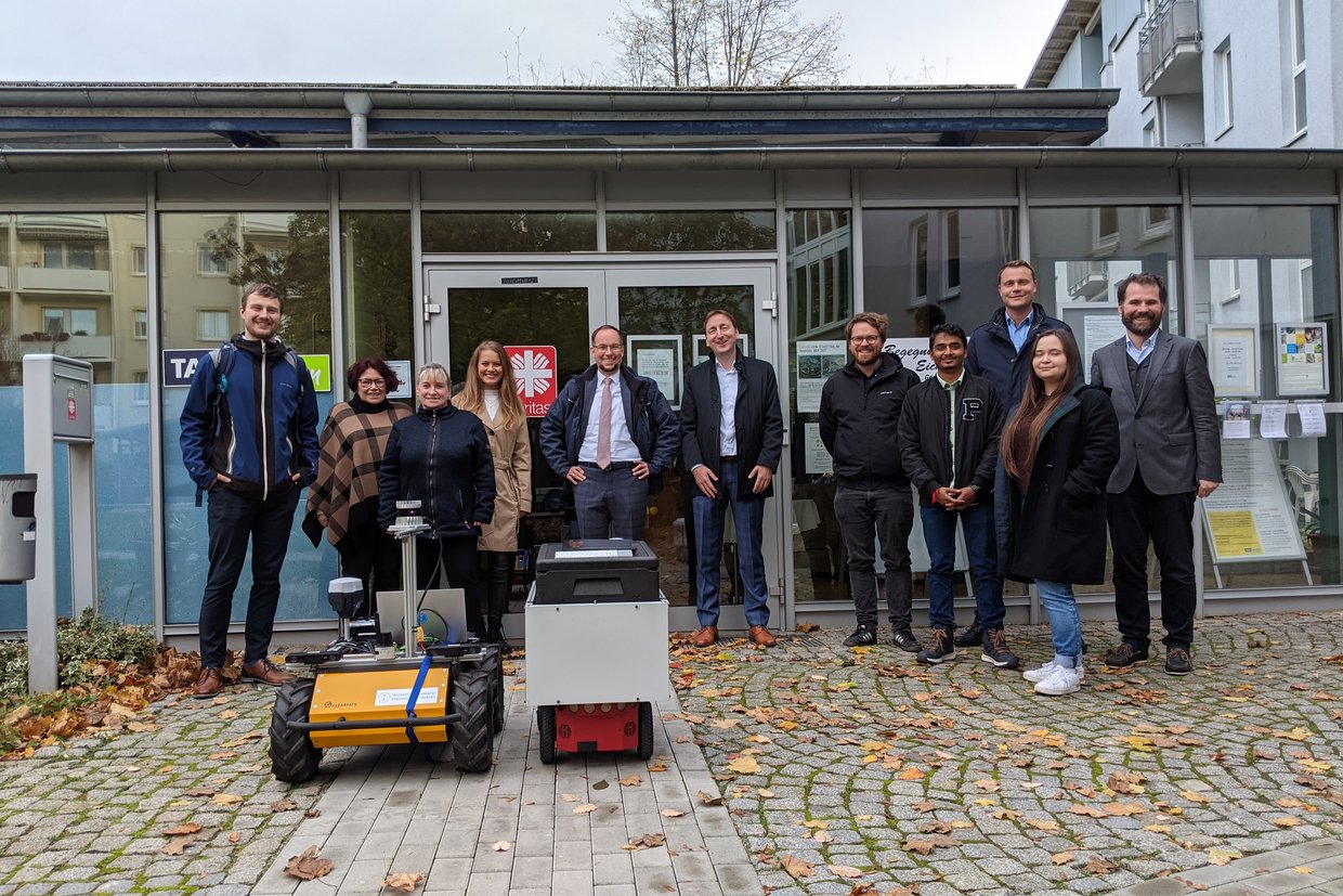 Das Projektteam mit den Lieferrobotern, die in Gera und Freiburg getestet werden.