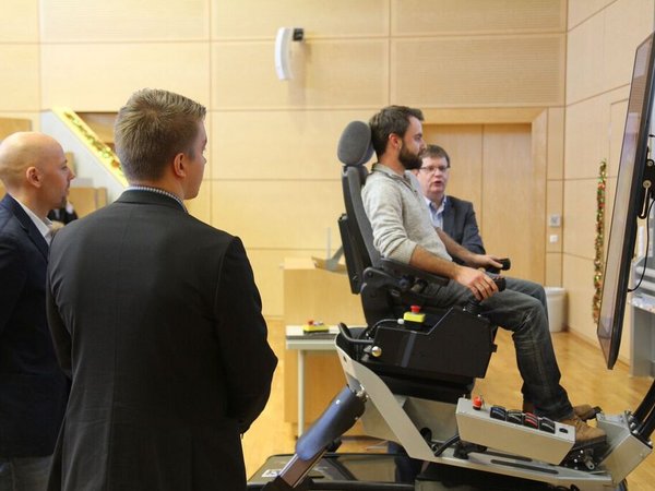 Participants in the excavator simulator